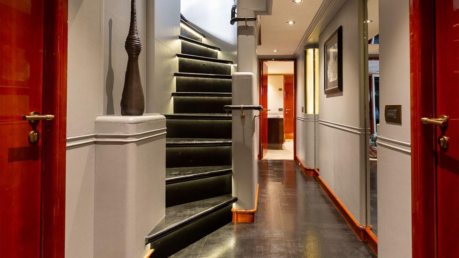 a hallway with red doors aboard IL SOLE Yacht for Charter