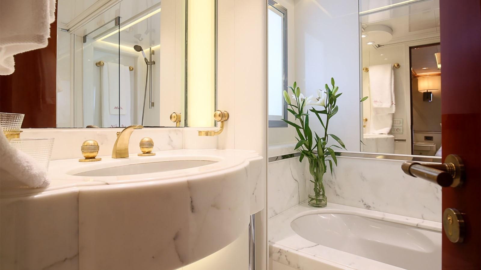 a bathroom with a sink and a mirror aboard IL SOLE Yacht for Charter