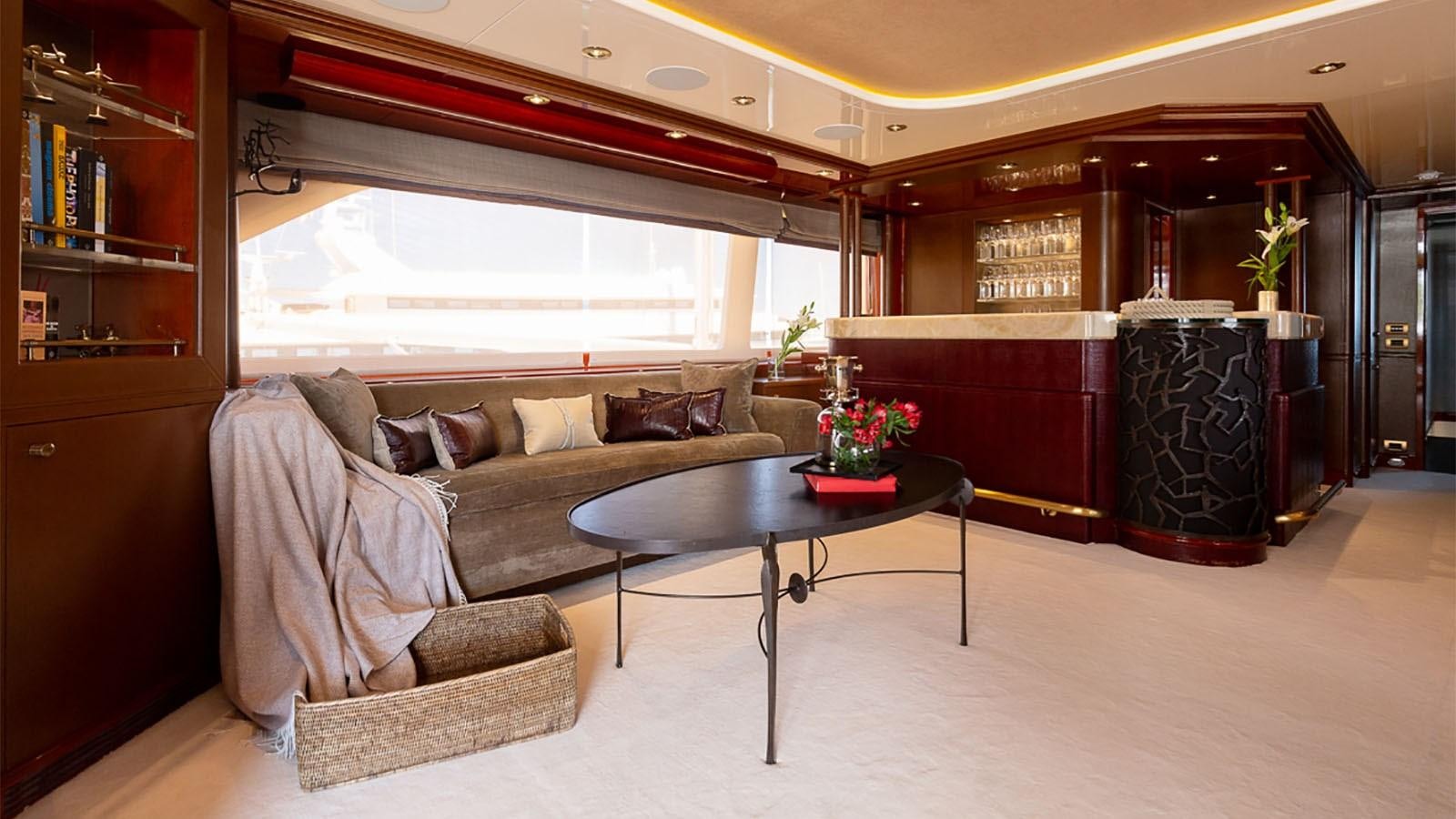 a living room with a couch and coffee table aboard IL SOLE Yacht for Charter