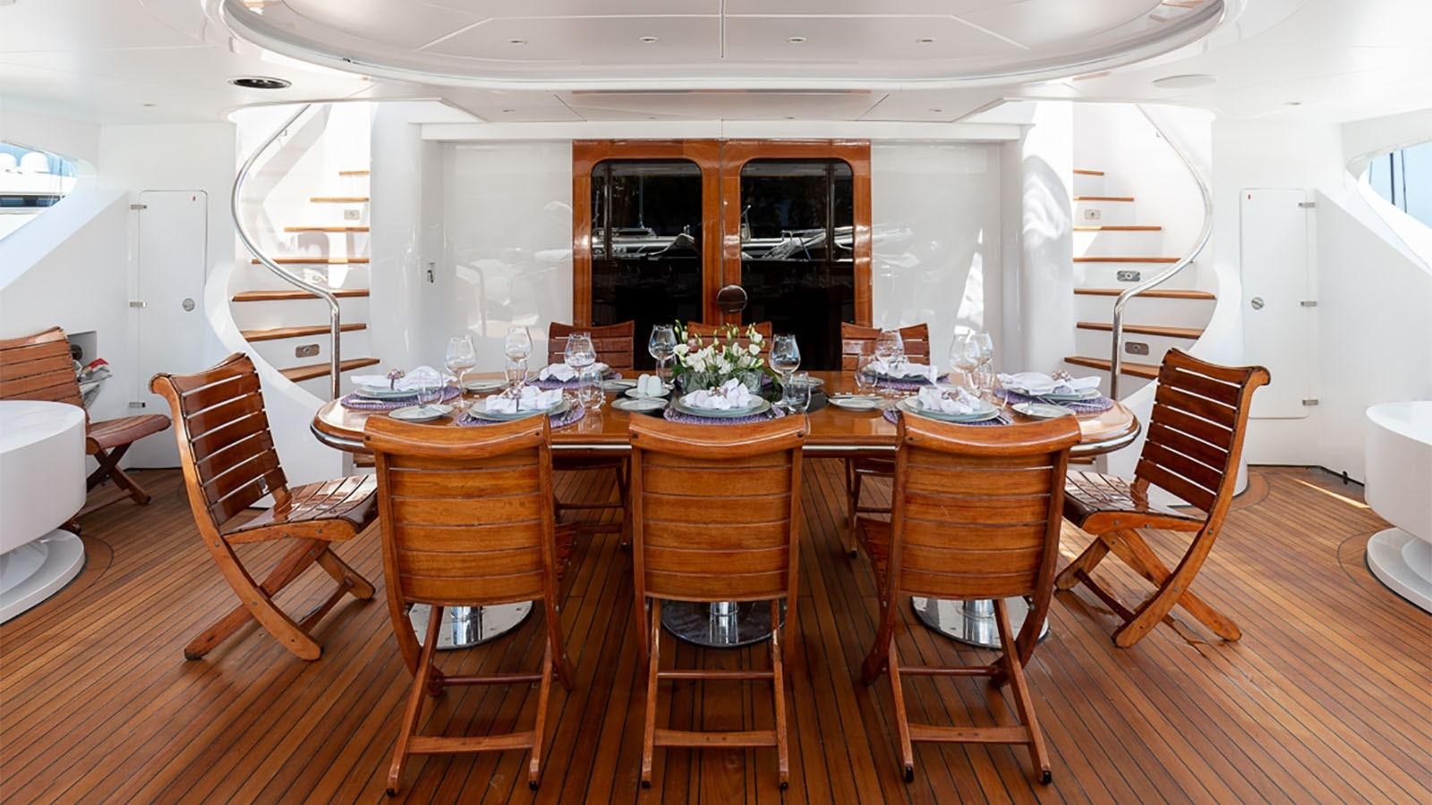 a dining room table and chairs aboard IL SOLE Yacht for Charter