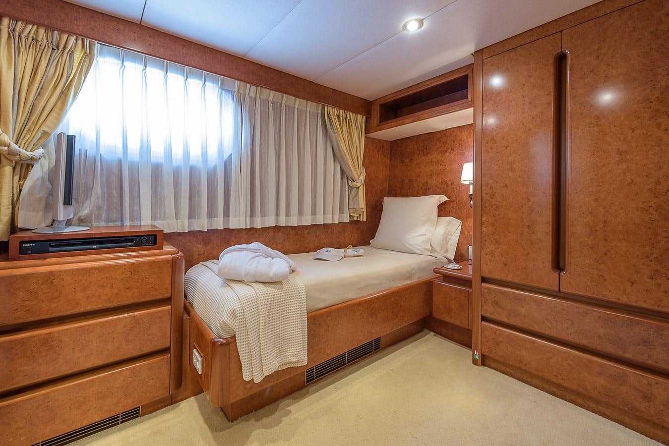 a bedroom with a bed and a dresser aboard CD TWO Yacht for Sale