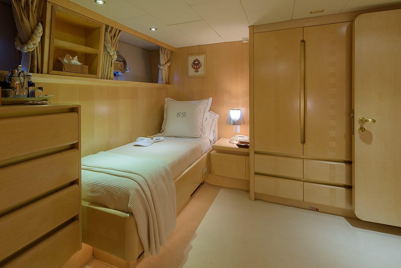 a hotel room with a bed and cabinets aboard CD TWO Yacht for Sale