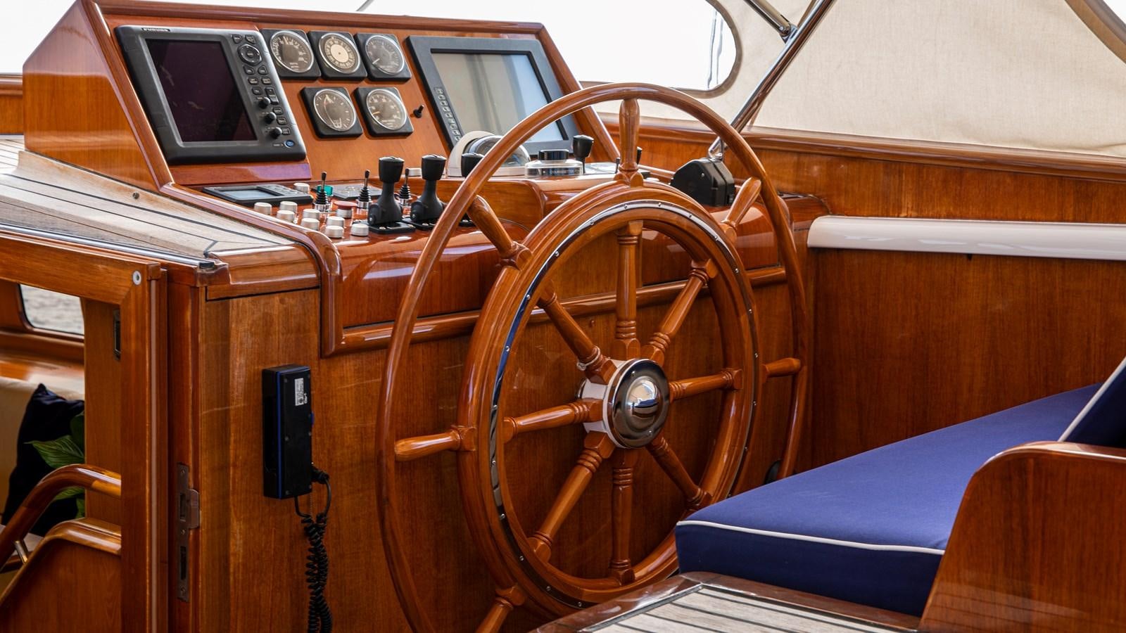 a wooden boat with a steering wheel aboard SOUTHWIND OF Yacht for Sale