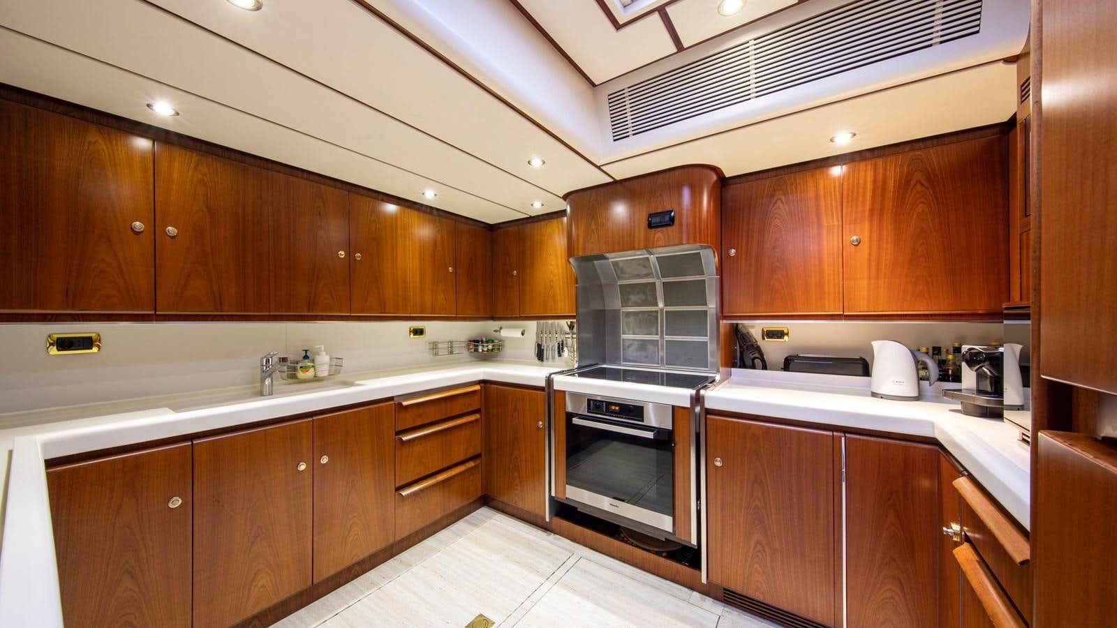 a kitchen with wooden cabinets aboard SOUTHWIND OF Yacht for Sale
