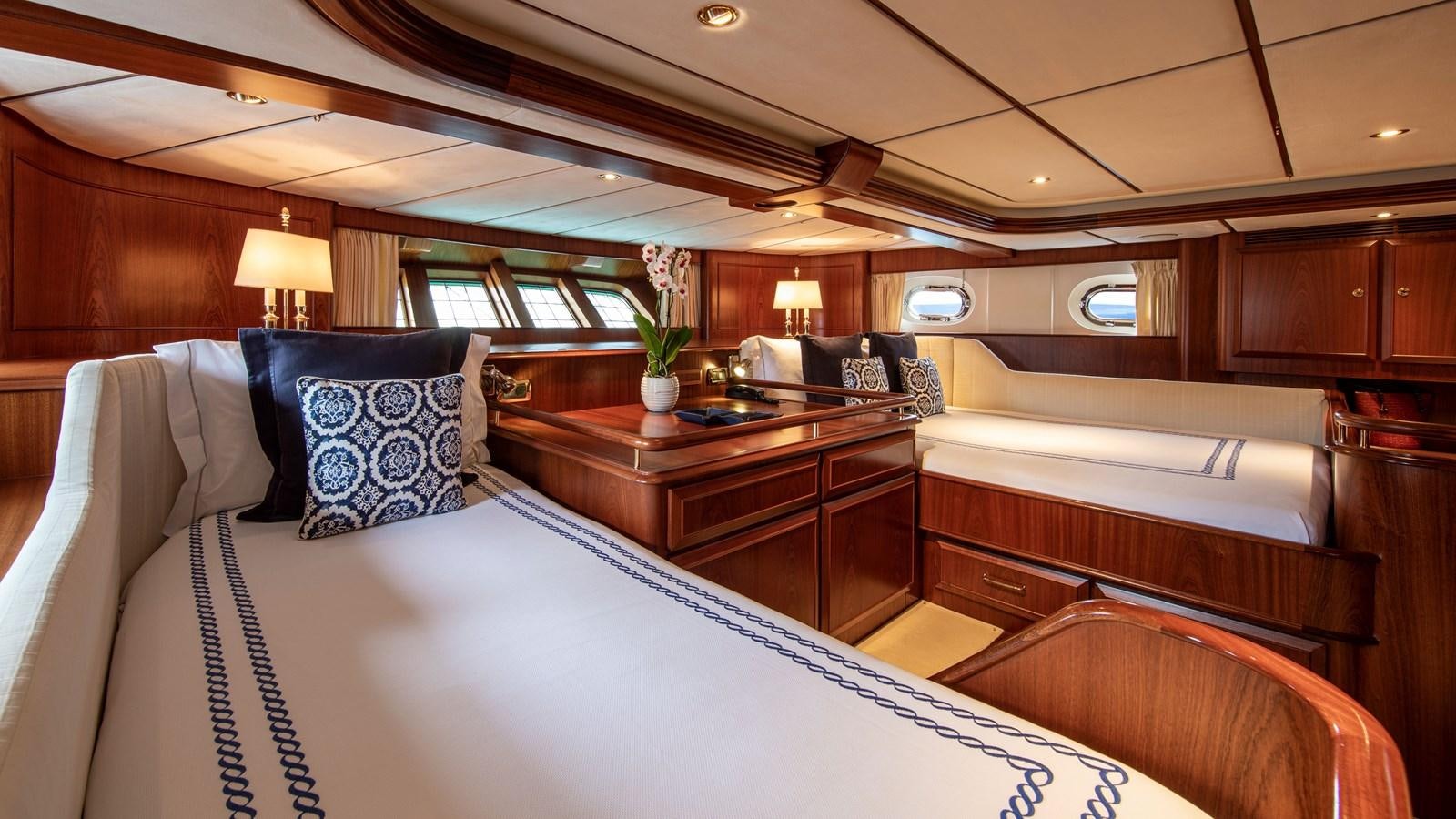 a room with a bed and desk aboard SOUTHWIND OF Yacht for Sale