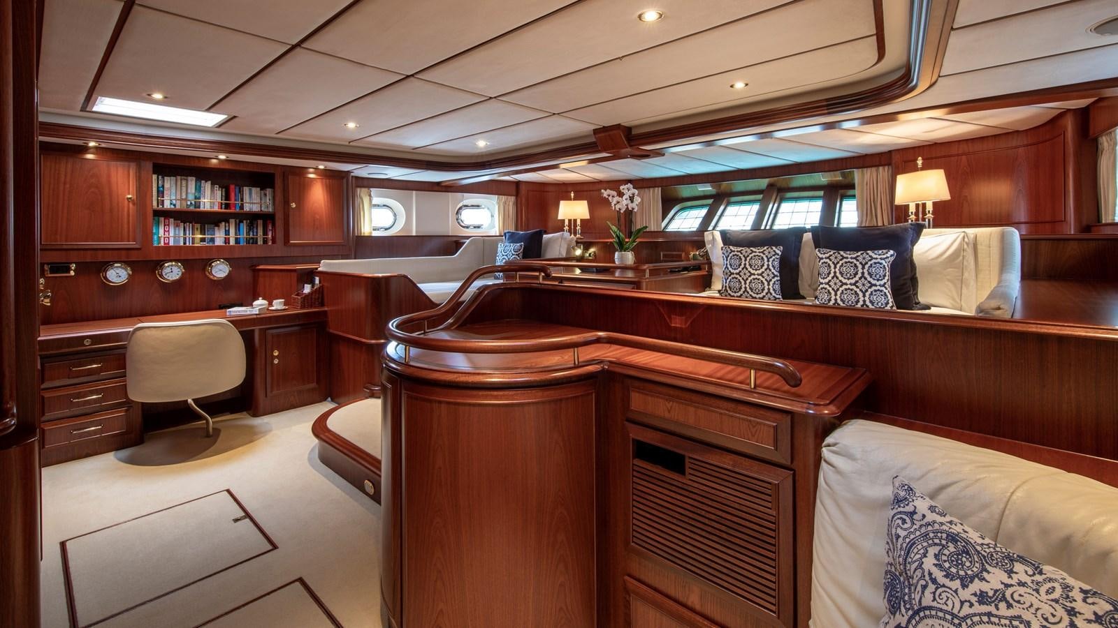 a room with a bed and desk aboard SOUTHWIND OF Yacht for Sale