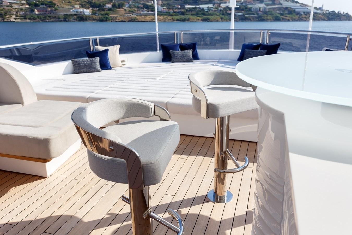 a table and chairs on a deck aboard NO.9 Yacht for Charter