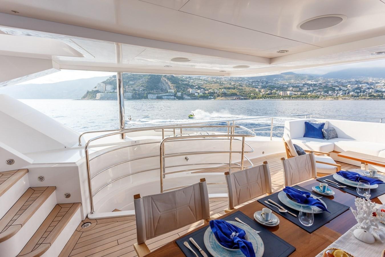 a room with a table chairs and a large body of water aboard NO.9 Yacht for Charter