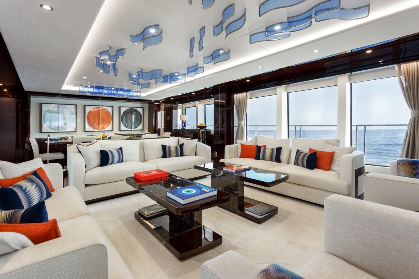 a living room with white couches and a coffee table aboard NO.9 Yacht for Charter