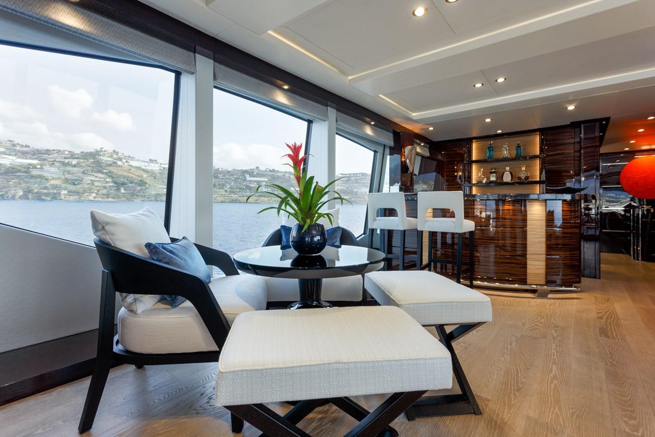 a room with a table chairs and a window aboard NO.9 Yacht for Charter