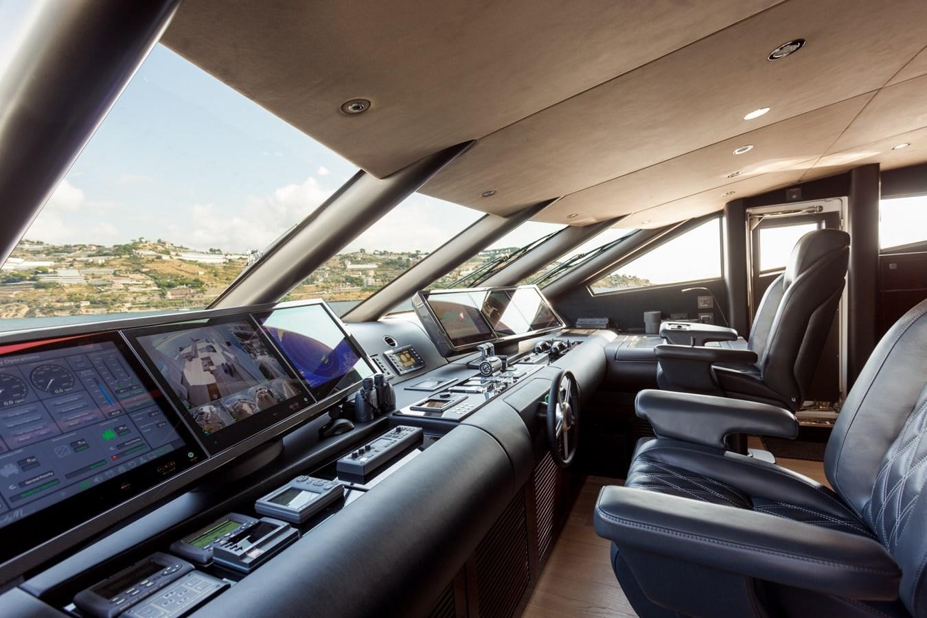 inside of a car with many monitors and laptops on the seats aboard NO.9 Yacht for Charter