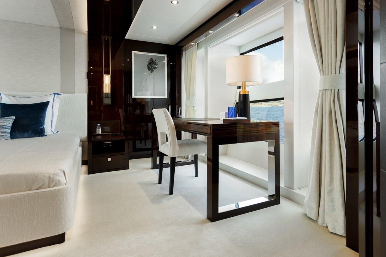 a bedroom with a desk and a bed aboard NO.9 Yacht for Charter