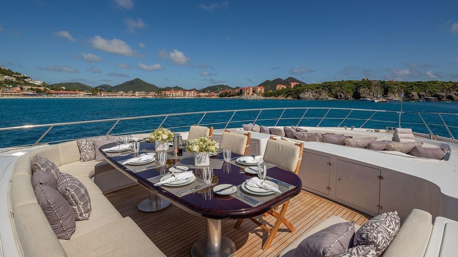a table set for a dinner on a boat aboard JOMAR Yacht for Sale