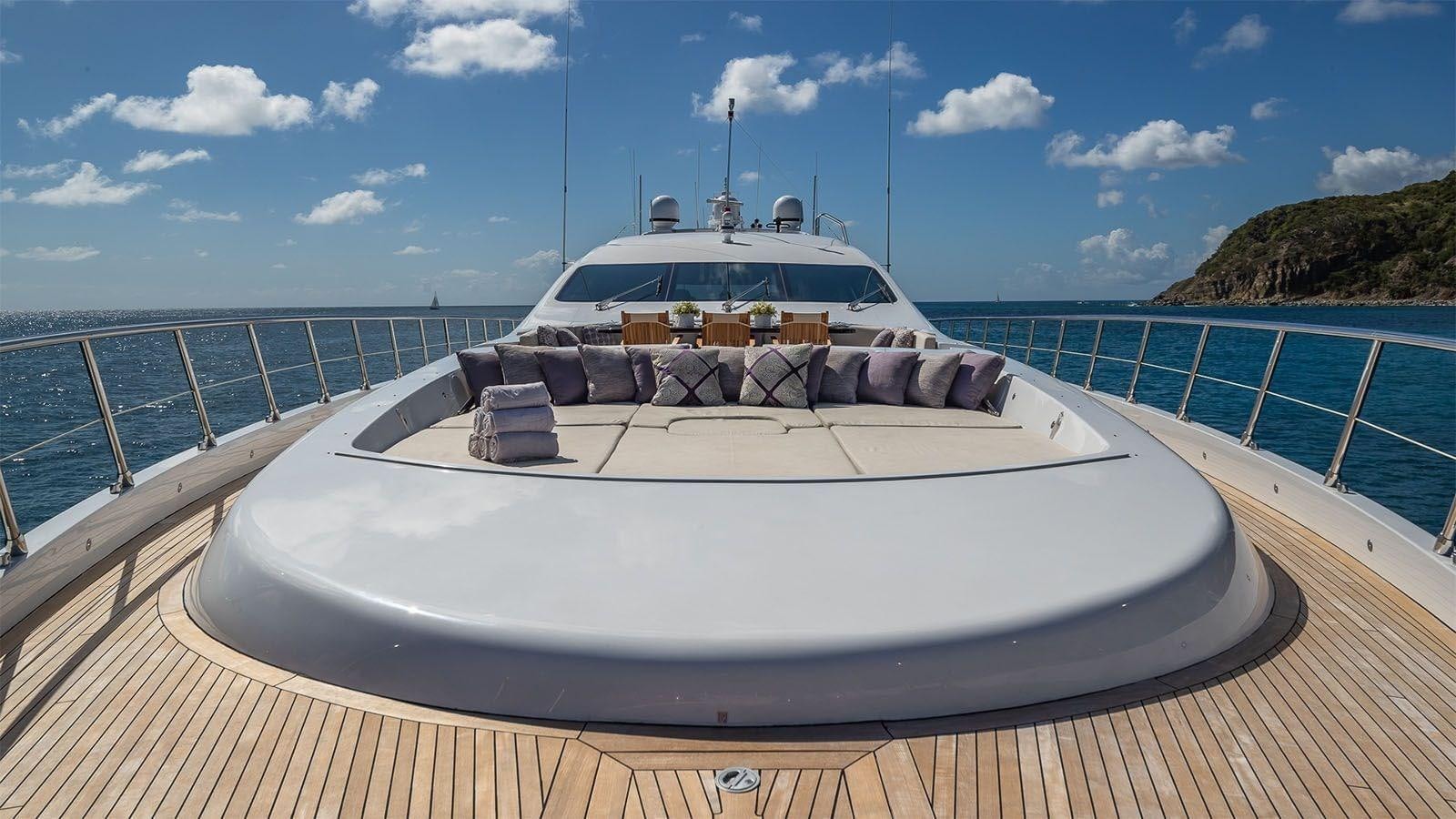 a white boat on a deck aboard JOMAR Yacht for Sale