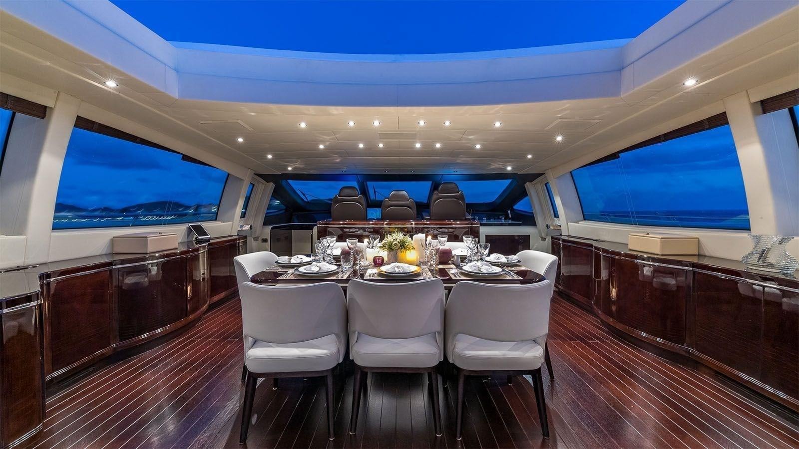a large dining room with a table and chairs aboard JOMAR Yacht for Sale