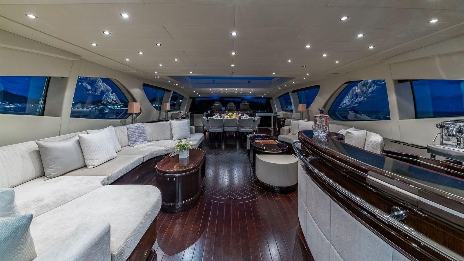 a large living room with a wood floor aboard JOMAR Yacht for Sale
