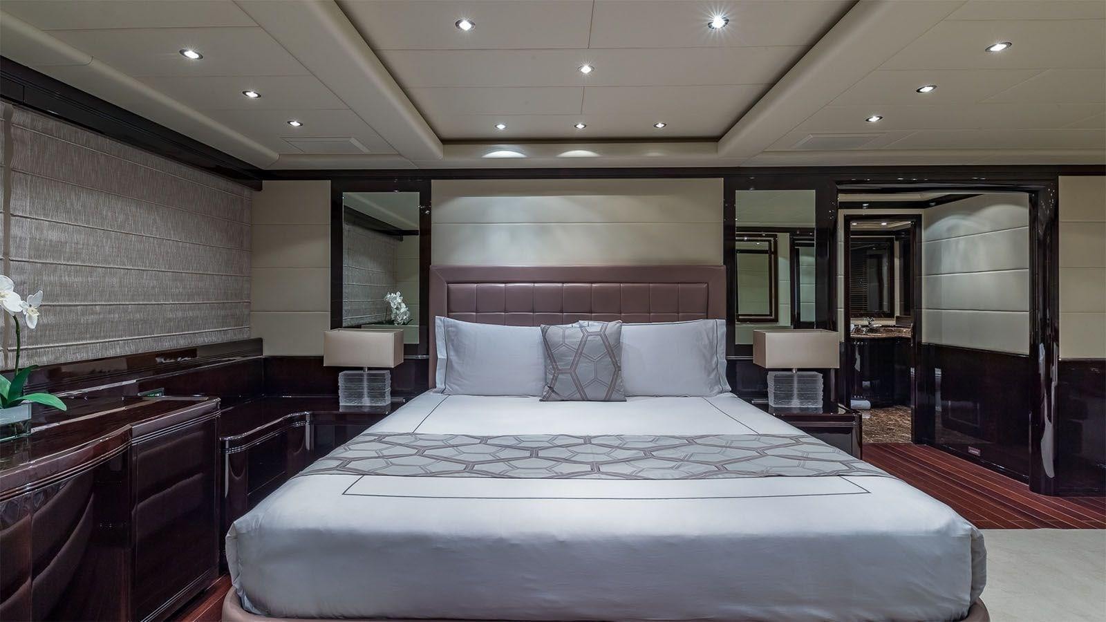a large bed in a hotel room aboard JOMAR Yacht for Sale