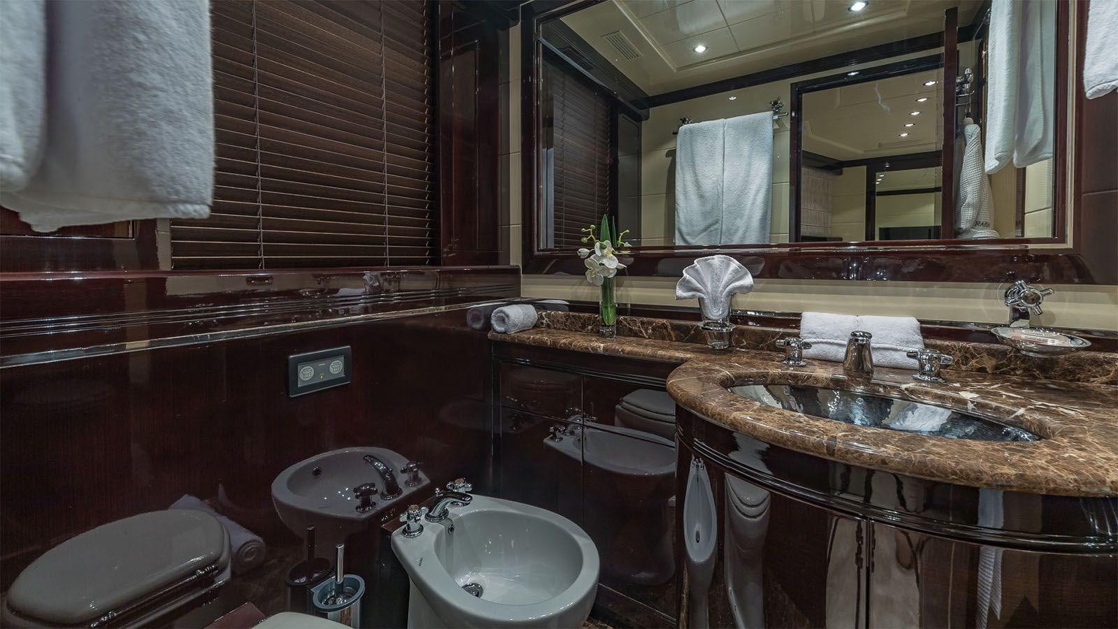 a bathroom with a sink and a mirror aboard JOMAR Yacht for Sale