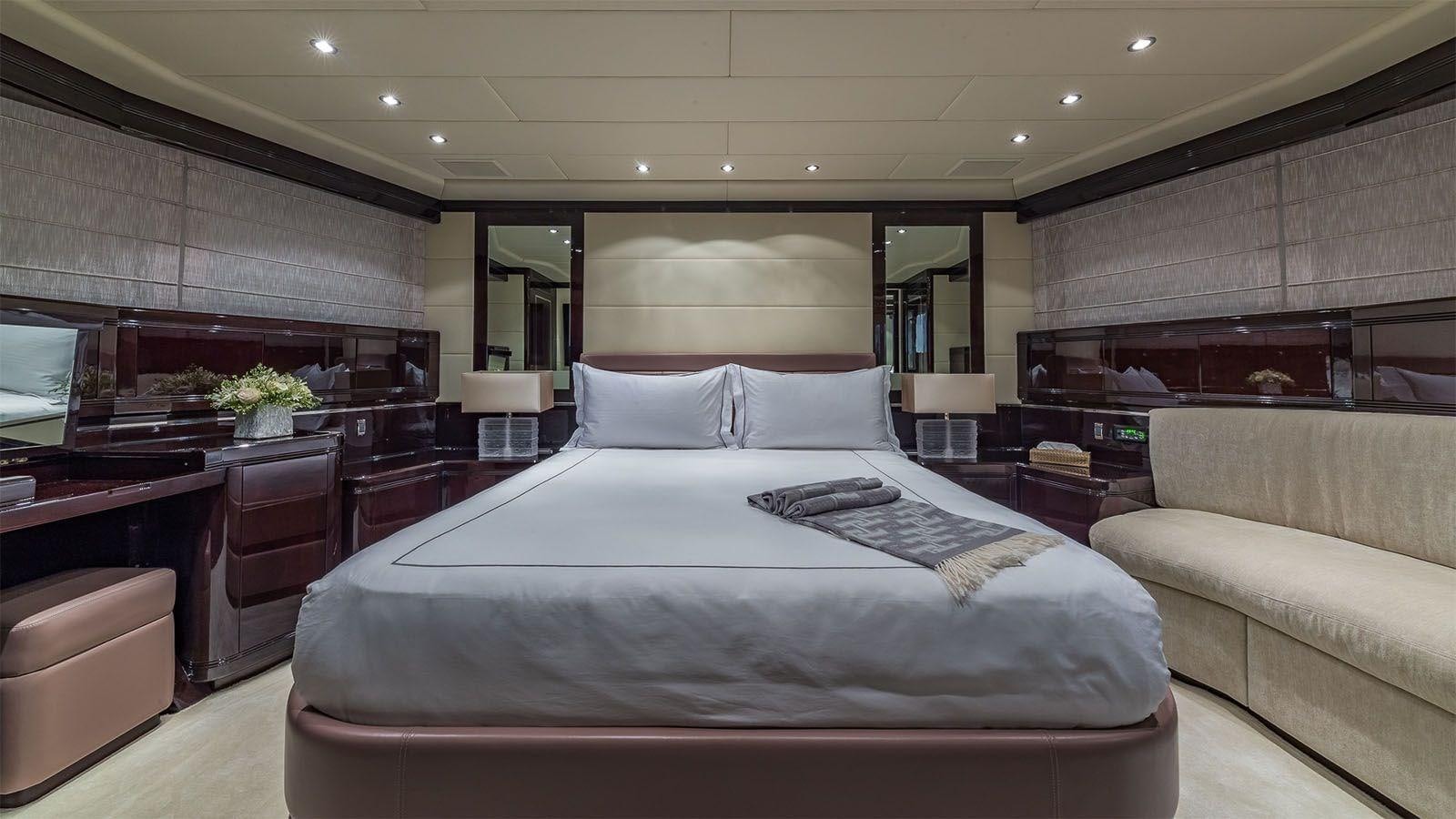 a large bedroom with a large bed aboard JOMAR Yacht for Sale