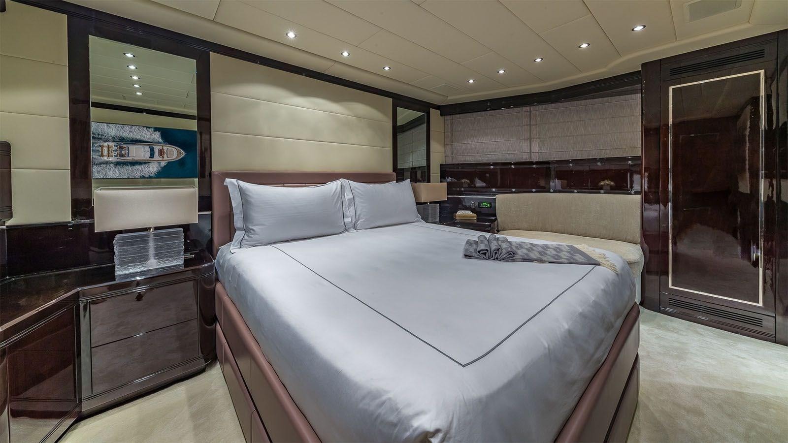 a room with a bed and a desk aboard JOMAR Yacht for Sale