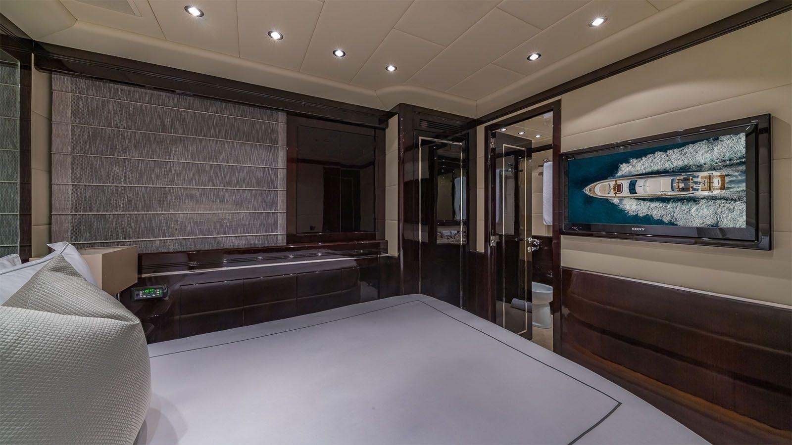 a room with a bed and a tv aboard JOMAR Yacht for Sale