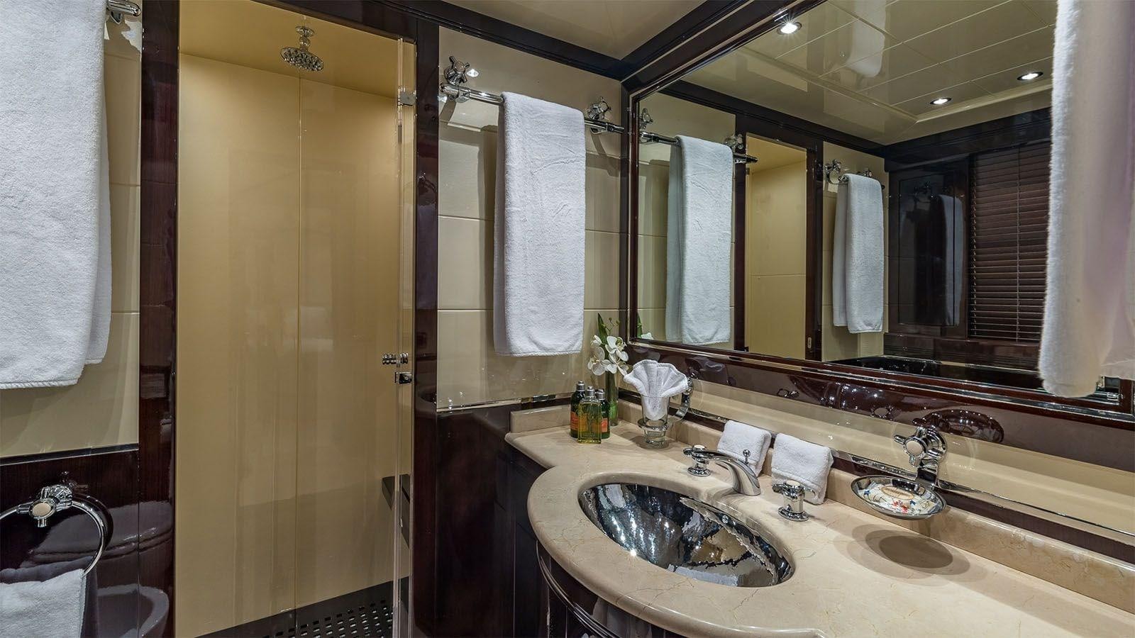 a bathroom with a sink and a mirror aboard JOMAR Yacht for Sale