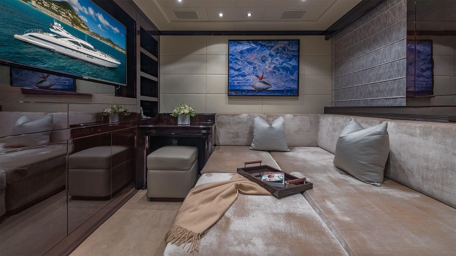 a living room with a couch and a coffee table aboard JOMAR Yacht for Sale