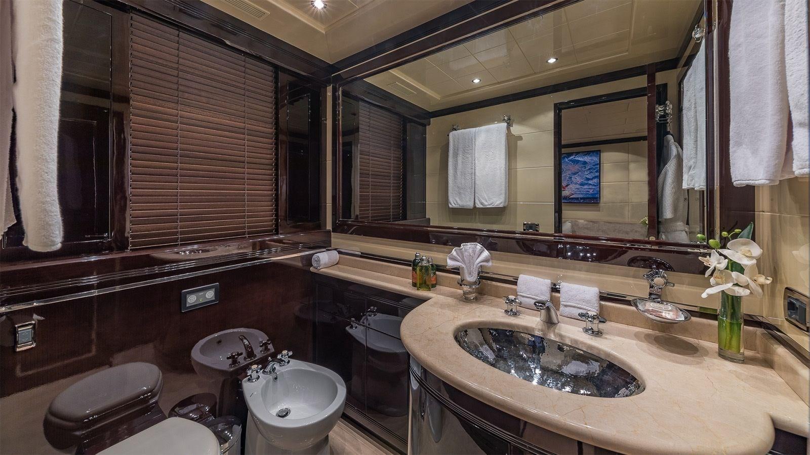 a bathroom with a large mirror aboard JOMAR Yacht for Sale