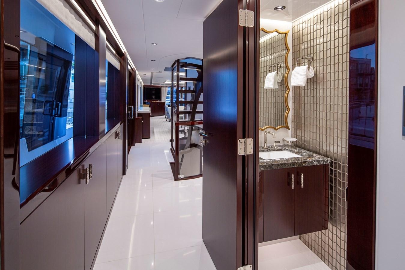 a hallway with a glass wall aboard LION'S DEN Yacht for Sale