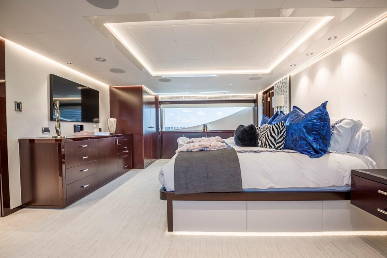 a bedroom with a large bed aboard LION'S DEN Yacht for Sale