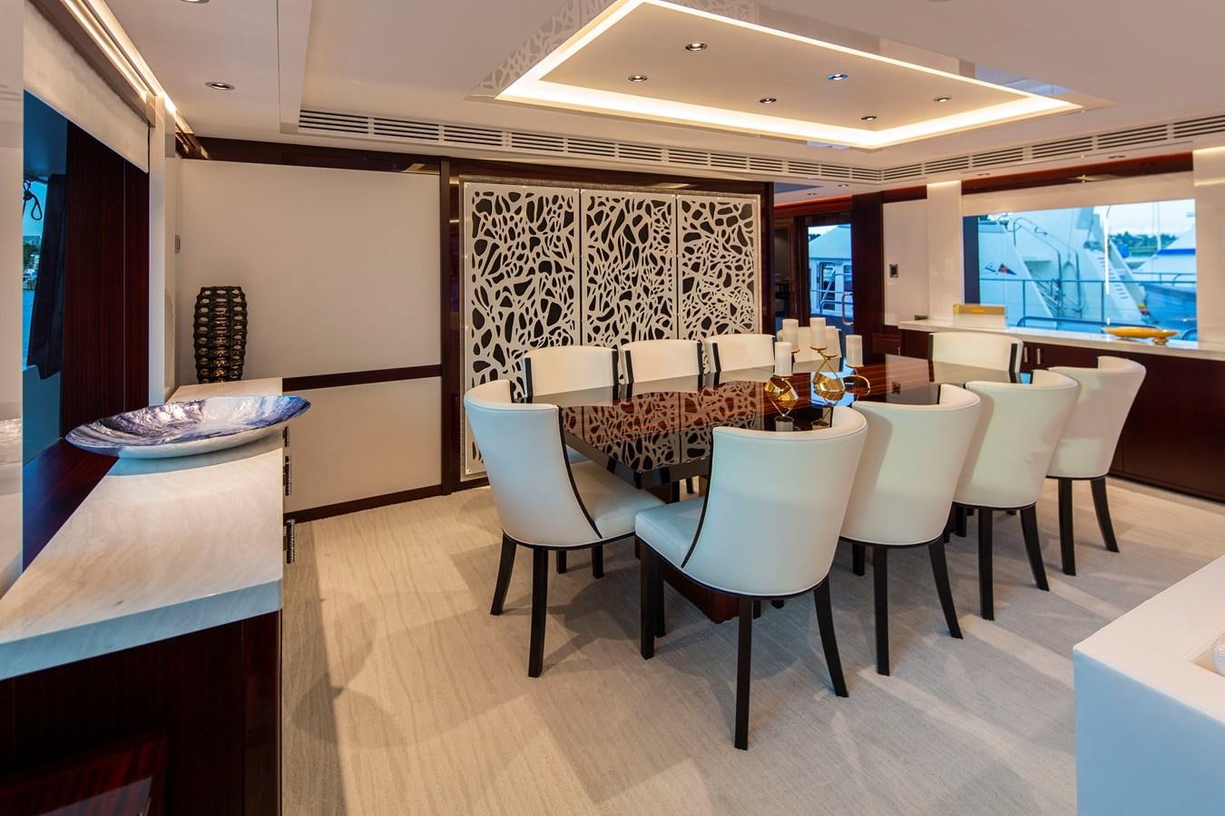 a room with tables and chairs aboard LION'S DEN Yacht for Sale