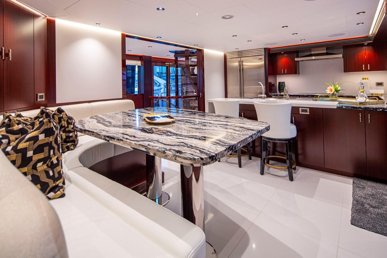 a kitchen with a table and chairs aboard LION'S DEN Yacht for Sale