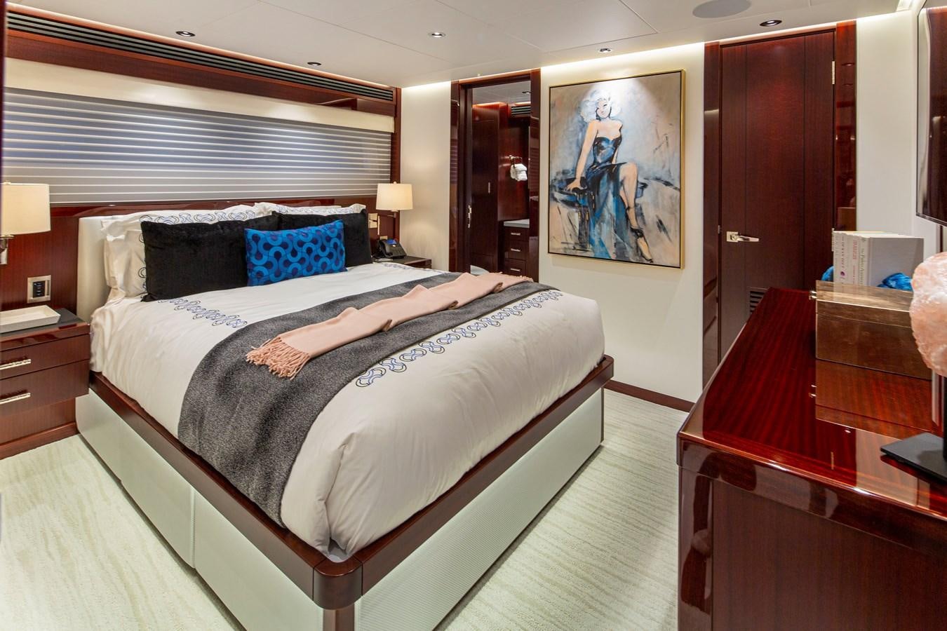 a bedroom with a bed and a desk aboard LION'S DEN Yacht for Sale
