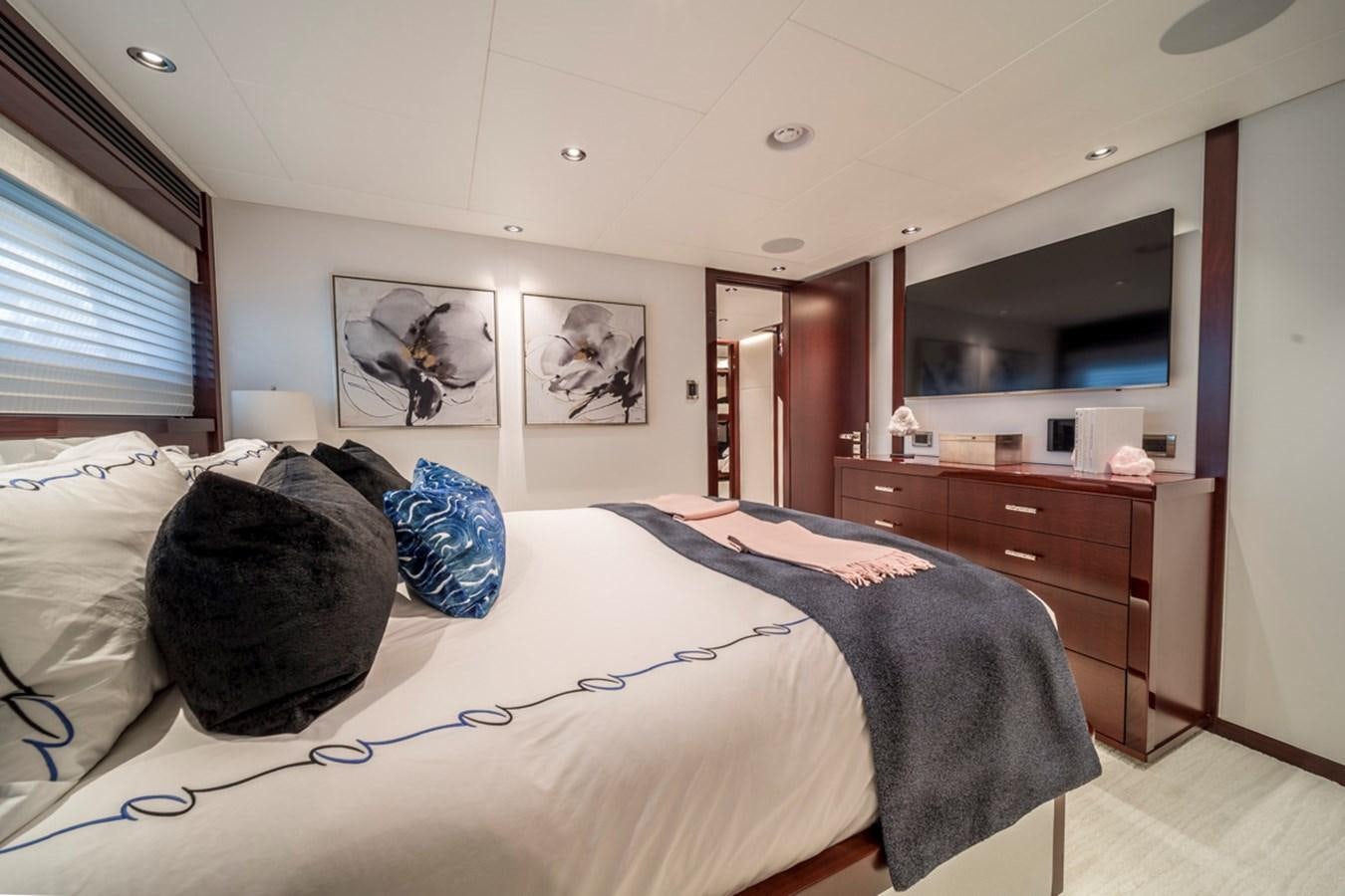 a bedroom with a large bed aboard LION'S DEN Yacht for Sale