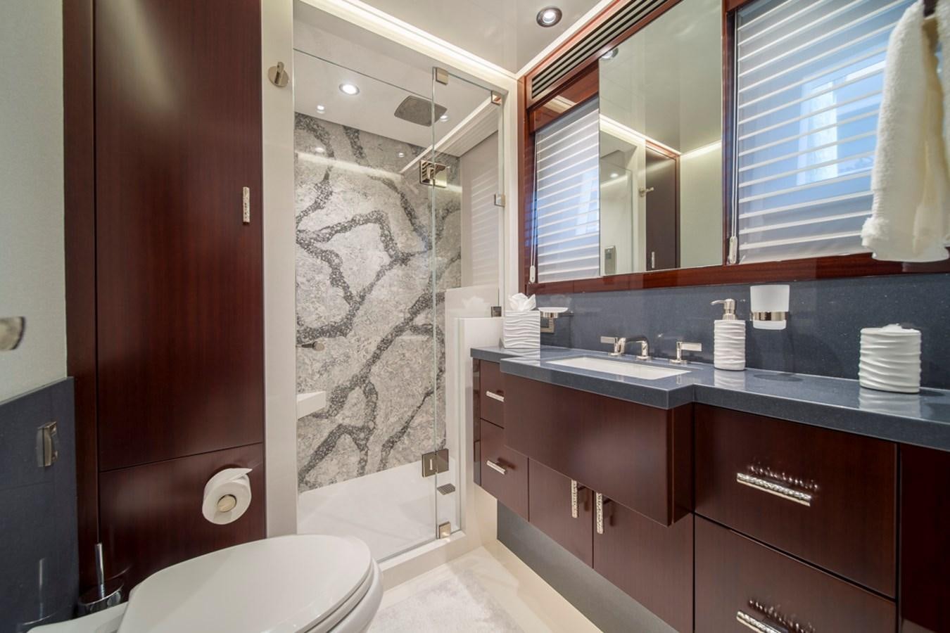 a bathroom with a sink and a toilet aboard LION'S DEN Yacht for Sale