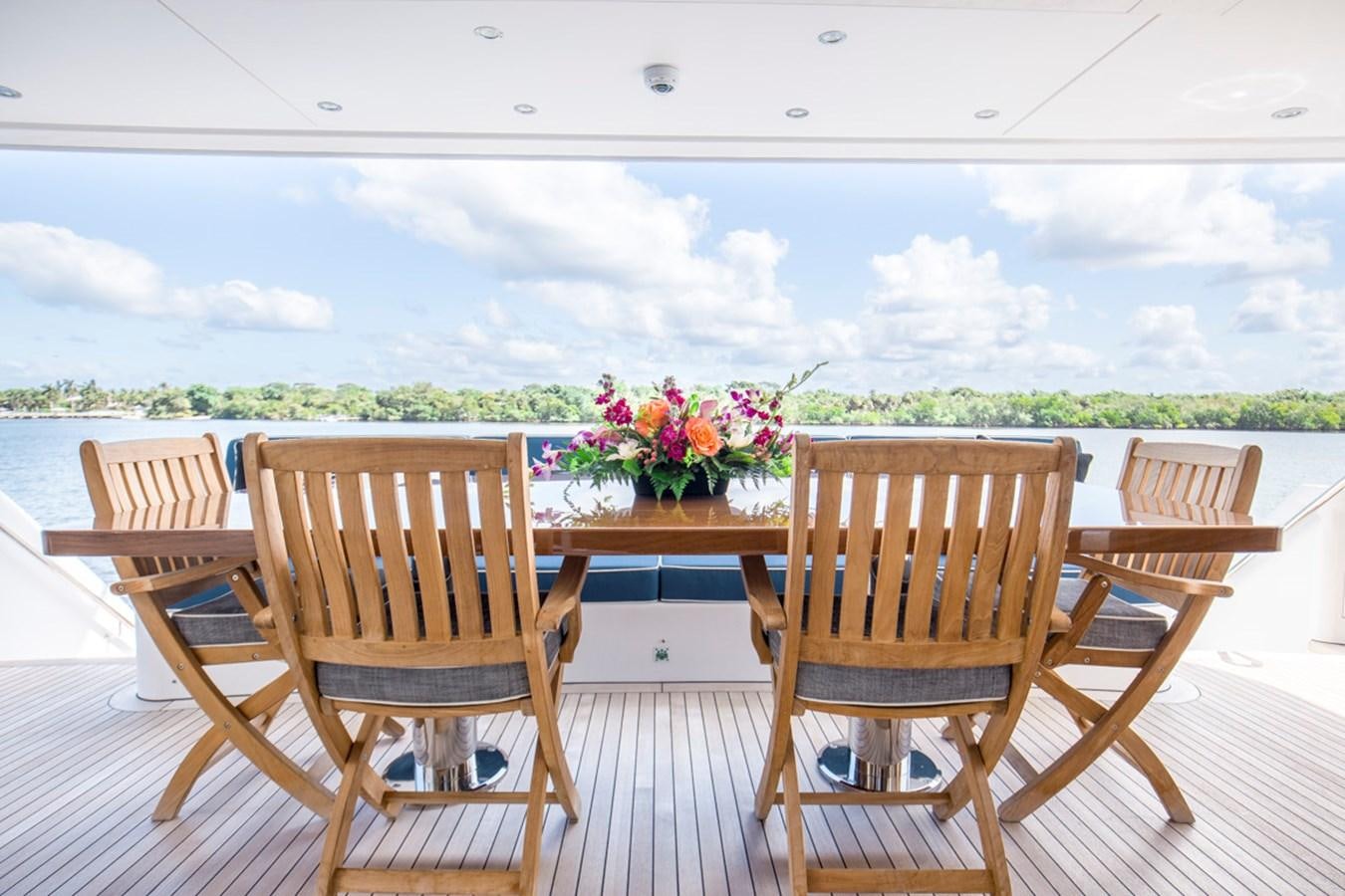 a deck with chairs and flowers on it aboard LION'S DEN Yacht for Sale