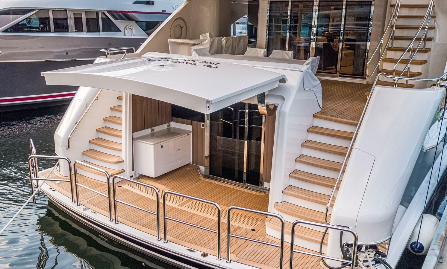 a white boat on a deck aboard LION'S DEN Yacht for Sale