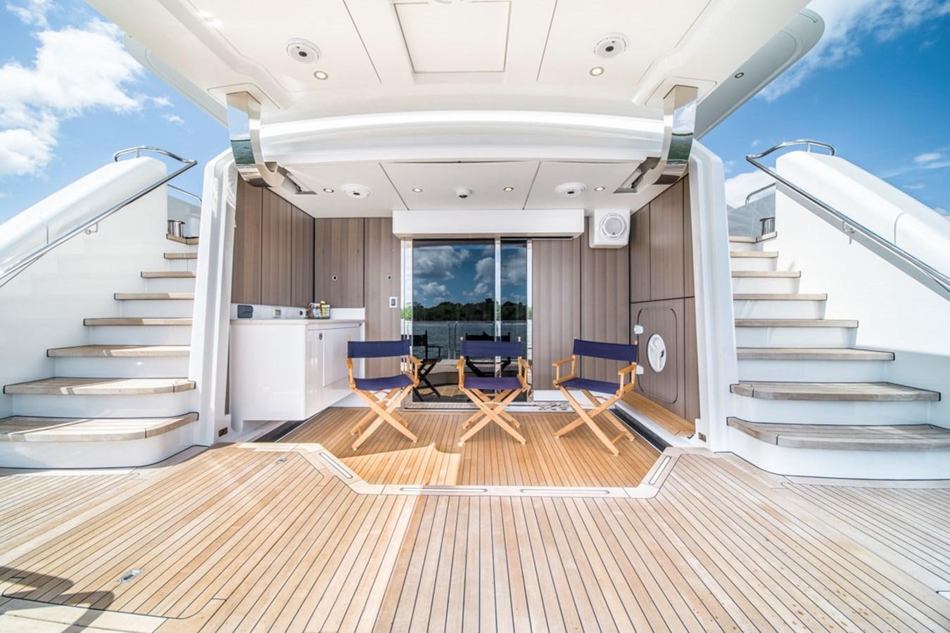 a large open space with chairs and a staircase aboard LION'S DEN Yacht for Sale