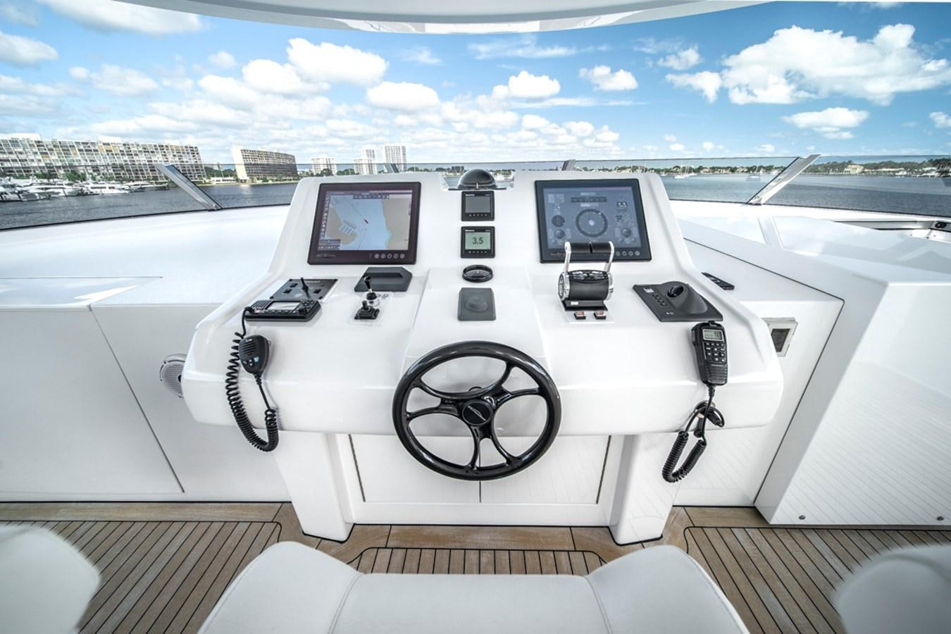 a white car with a screen and a steering wheel on a deck aboard LION'S DEN Yacht for Sale