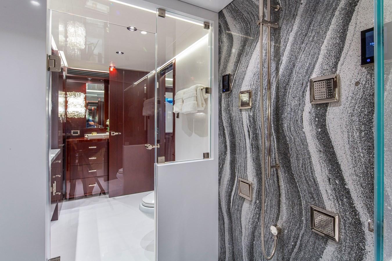 a bathroom with a glass shower aboard LION'S DEN Yacht for Sale