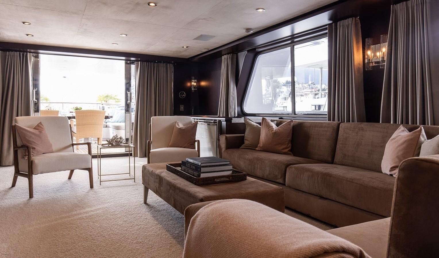 a living room with a couch and a coffee table aboard CALLISTA Yacht for Sale