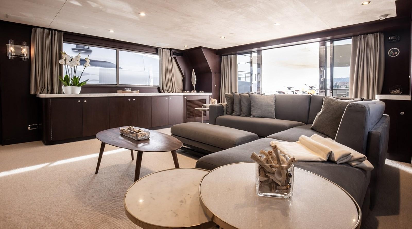 a living room with a couch and coffee table aboard CALLISTA Yacht for Sale