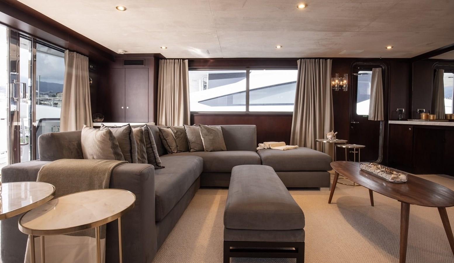 a living room with a couch and a table aboard CALLISTA Yacht for Sale
