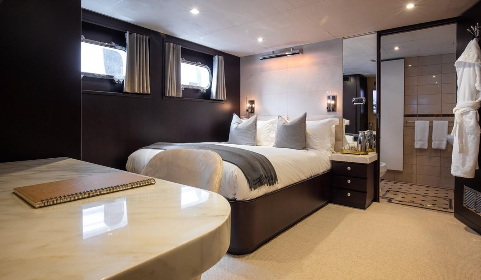 a room with a bed and a table aboard CALLISTA Yacht for Sale