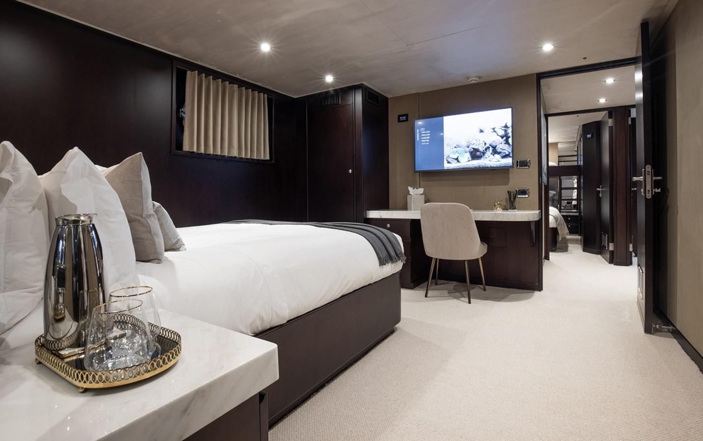 a room with a bed and a table aboard CALLISTA Yacht for Sale