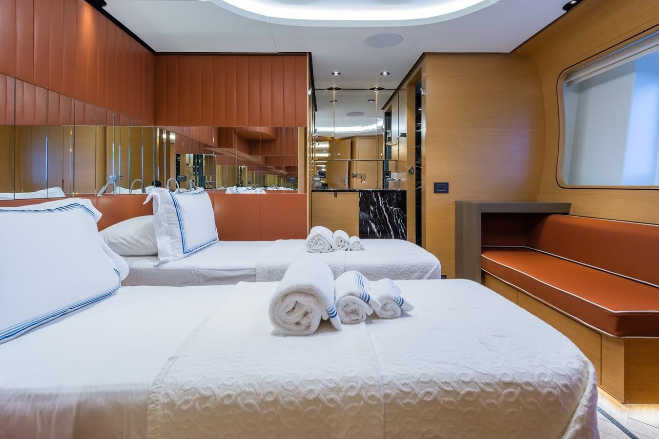 a room with a bed and a bench aboard LEONIDAS Yacht for Sale