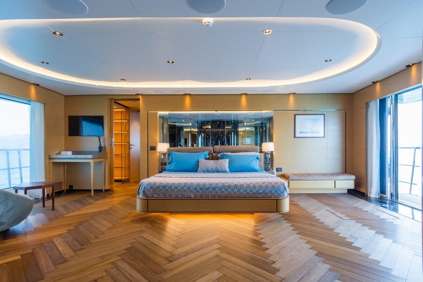 a bedroom with a bed and a desk aboard LEONIDAS Yacht for Sale