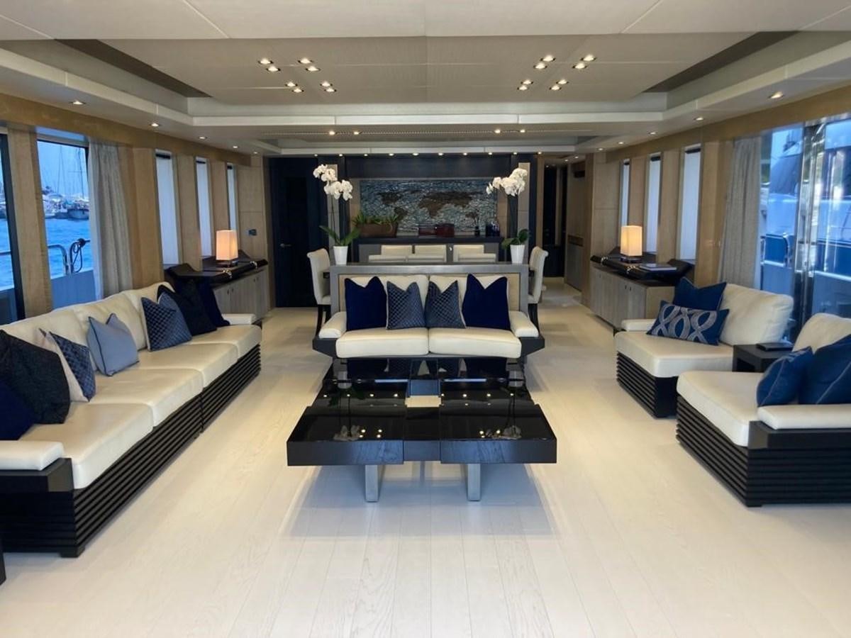 a room with a couch and a table and a bed aboard R2 Yacht for Sale