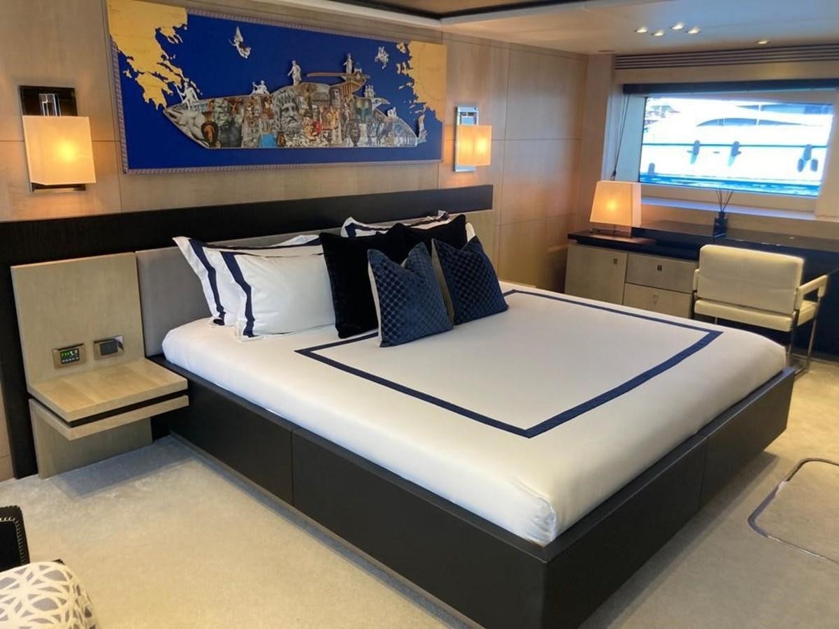 a bed with blue sheets aboard R2 Yacht for Sale