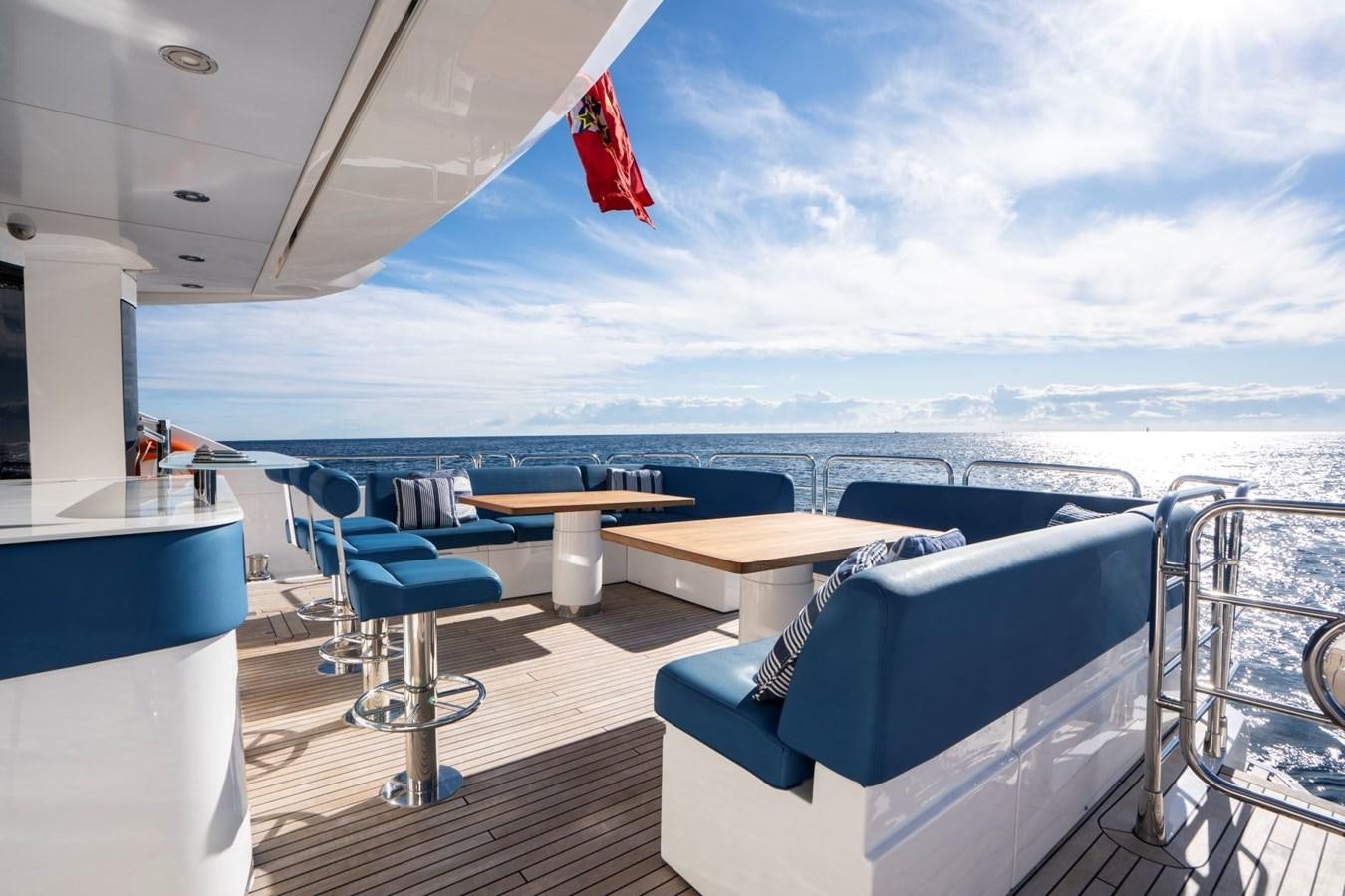 a room with a table and chairs aboard R2 Yacht for Sale